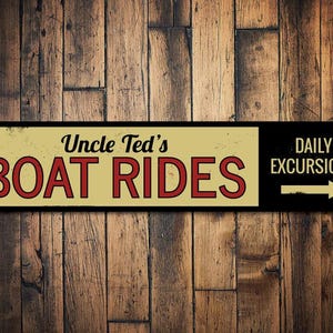 May include: A vintage-style sign with black and white text on a yellow background. The sign reads "Uncle Ted's Boat Rides" and "Daily Excursions" with a black arrow pointing to the right.