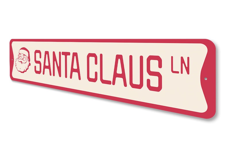 Op de afbeelding: Een rood en wit metalen bord met afgeronde hoeken waarop "SANTA CLAUS LN" staat met een cartoonafbeelding van de kerstman in de linkerbovenhoek.