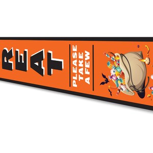 May include: Orange and black Halloween sign with the text "Trick or Treat" and "Please take a few". The sign features a cartoon illustration of a bag full of sweets and bats.
