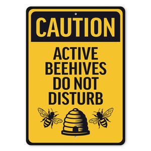 a caution sign that says, active beehives do not disturb