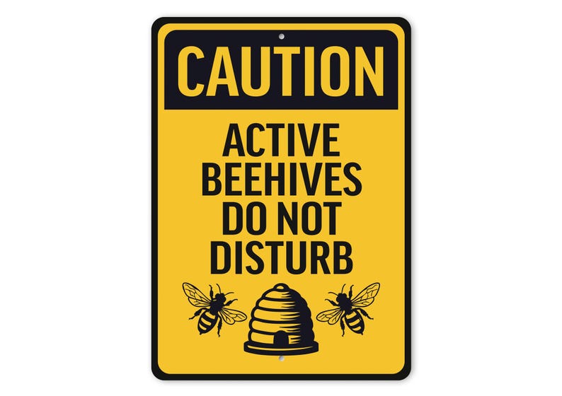 a caution sign that says, active beehives do not disturb