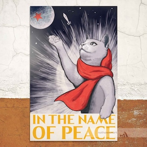 May include: A grey cat wearing a red scarf with a star on its chest, reaching up towards a rocket in a starry sky. The text "IN THE NAME OF PEACE" is at the bottom of the image.