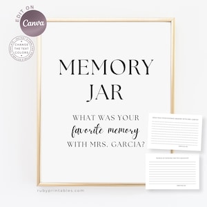 May include: A framed white sign with the words "MEMORY JAR" in large, bold, black font. Below, the text reads "WHAT WAS YOUR favourite memory WITH MRS. GARCIA?". Two small cards are included.