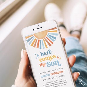 May include: A phone screen displaying a baby shower invitation with a colorful sun graphic and the text "here comes the Son". The invitation is for Andrea Rodriguez and is scheduled for Saturday, August 5th at 12pm at Limoncello Bistro & Bar.