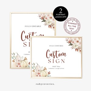 May include: Two framed signs with a fall theme. The signs feature the text "Custom Sign" in a dark brown script, with floral and pumpkin illustrations. The signs are 20.3 x 25.4 cm in size and fully editable.