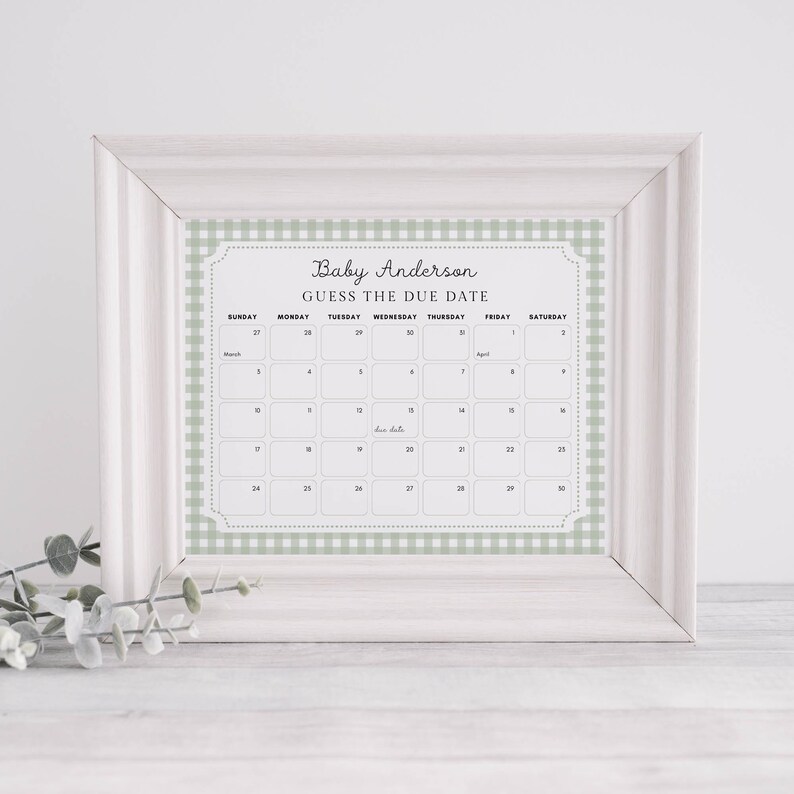 May include: A white framed calendar with a green and white gingham pattern. The calendar is titled "Baby Anderson Guess the Due Date" and has the months of March and April displayed.