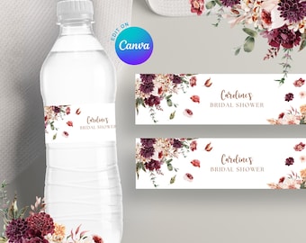 May include: A clear plastic water bottle with a white label featuring floral accents and the text "Carolines BRIDAL SHOWER." Additional labels with the same design are displayed. The design includes burgundy, cream, and peach-colored flowers.