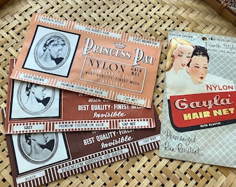 May include: Vintage nylon hair nets in various colors, including light brown, grey, and black. The packaging features illustrations of women and text such as "Princess Pat" and "Gayla Hair Net". The nets are described as having an elastic edge and fine mesh.