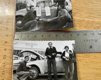 Vintage photo vw beetle pair man tools beside Volkswagen Bug winning car competition prize fixing hub caps black white old snapshot family