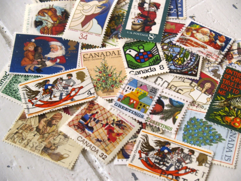 May include: A collection of vintage Christmas stamps featuring various holiday themes, including Santa Claus, a Christmas tree, a dove, and a rocking horse. The stamps are from different countries and years, and some have the words "Canada" and "US Postage" printed on them.