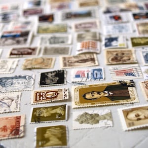 May include: A collection of vintage postage stamps from around the world. The stamps feature a variety of designs, including portraits, landscapes, and abstract art. Some of the stamps are in colour, while others are black and white. The stamps are arranged in a random pattern on a white surface.