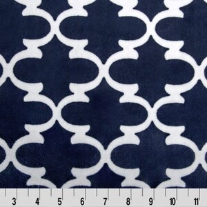 May include: Navy blue fabric with a white geometric pattern. The pattern is a repeating design of interlocking circles and arches.