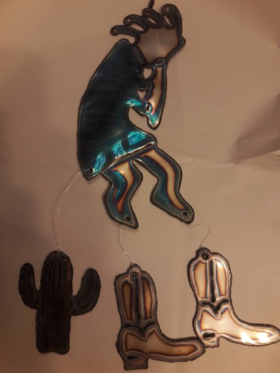 Kokopelli wind chime with cactus and boots hanging. Etsy