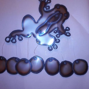 Frog wind chime with circles cut from stainless steel