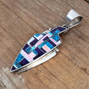 May include: A white ceramic mug with a black handle and the text "But First, Coffee" in a black, bold font. The mug is sitting on a wooden surface. The mug is approximately 4 inches tall.