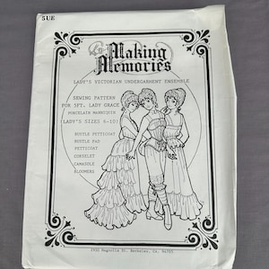 May include: A white paper sewing pattern envelope titled Making Memories for a Victorian undergarment ensemble. The front features black line art of three figures wearing a bustle petticoat, bustle pad, corselet, camisole, and bloomers.