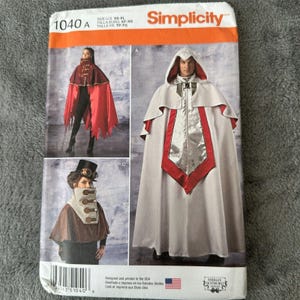 May include: Simplicity pattern 1040 A for capes. The package features images of capes in red, white, and brown. The capes have hoods and decorative elements. The package also includes the size range: XS-XL.