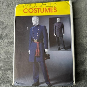 May include: A McCall's Costumes pattern envelope featuring a navy blue military uniform design. The uniform has gold buttons, a red sash, and a matching pair of pants. A smaller image shows a similar uniform in a different style.