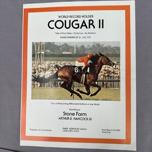 May include: A vintage print featuring a racehorse named Cougar II, a world record holder. The image shows a jockey in red and a brown horse with the number 6. Text includes "Stone Farm" and "Paris, Kentucky."