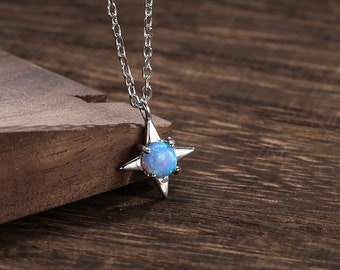 May include: A silver chain necklace with a blue opal star pendant.