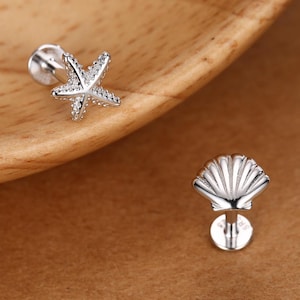 May include: A set of three ceramic mugs with a speckled, matte finish. The mugs are in shades of cream, light gray, and dark gray. Each mug has a simple, minimalist design, perfect for coffee or tea.