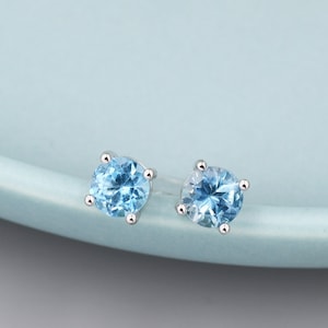 Peut inclure: Une paire de boucles d'oreilles en argent avec des pierres rondes bleu clair.