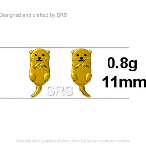 May include: A pair of gold-colored otter earrings, each measuring 11mm in size and weighing 0.8 grams. The earrings are designed and crafted by SRS.