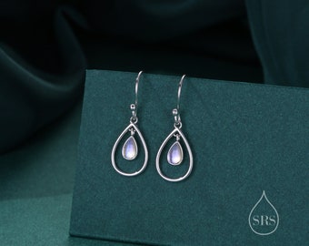 May include: A pair of silver dangle earrings with a teardrop-shaped moonstone in the center of each earring.