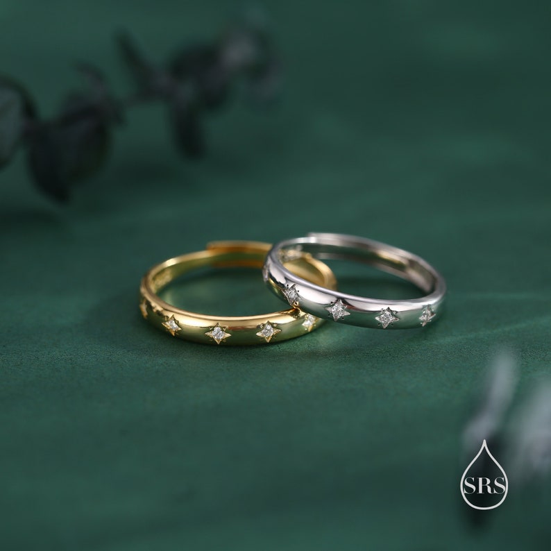 May include: Two simple wedding bands with a row of small diamonds. The band on the left is gold and the band on the right is silver.