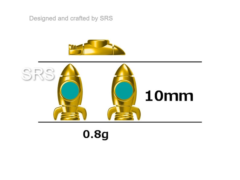 May include: Two gold-colored rocket ship charms with teal blue windows. The charms are 10mm in size and weigh 0.8 grams. The text "SRS" is visible in the image.