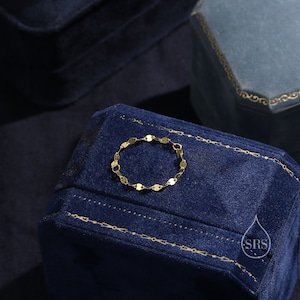 May include: A gold chain bracelet with small, oval-shaped links. The bracelet is displayed on a blue velvet box.
