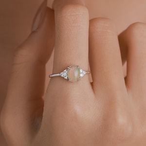 May include: A set of three ceramic mugs with a speckled, matte finish. The mugs are in shades of cream, light gray, and dark gray. Each mug has a simple, minimalist design, perfect for coffee or tea.