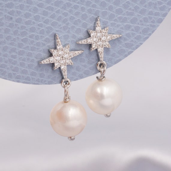 Northstar - Orecchini pendenti a forma di stella, in argento, a forma