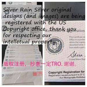 May include: A stack of copyright registration certificates for Silver Rain Silver designs and images. The certificates are from the United States Copyright Office. The text on the certificate reads "This Certificate is issued by the United States Copyright Office in accordance with 17 U.S.C. 411. This Certificate attests that registration has been made a part of the records of the Copyright Office." The text on the bottom of the certificate reads "Copyright Registration for Photographs Published".