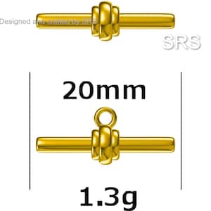 May include: Gold-toned metal toggle clasp with a 20 mm length and a weight of 1.3 grams.  The clasp has a round, decorative design with a loop at the top.