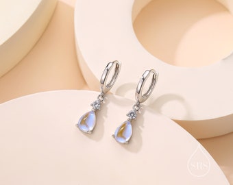 May include: Silver hoop earrings with a teardrop-shaped iridescent stone and a small clear stone accent.