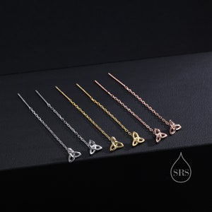 Könnte beinhalten: Sechs Paar Ohrringe mit einem keltischen Knotendesign. Die Ohrringe sind in Silber, Gold und Roségold erhältlich.