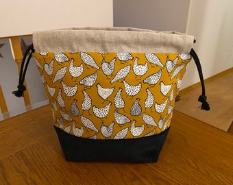 Cute barnyard chickens with black corduroy on the front bottom. Drawstring project bag.