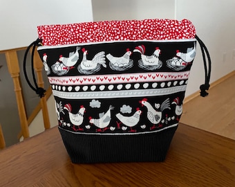 Black/red chickens and eggs with black corduroy on the front.  Drawstring project bag