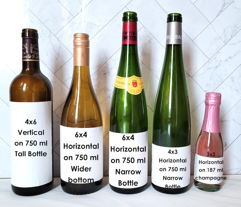 May include: Five wine bottles with labels showing different sizes and orientations for printing labels. The labels show the dimensions of the label, the orientation, the bottle size, and the bottle type. The bottles are arranged from left to right in order of increasing size.