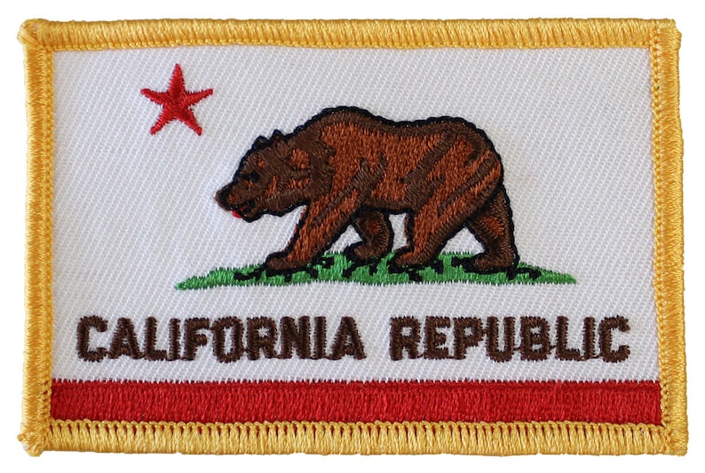 May include: Embroidered patch featuring the California state flag. The patch is white with a red star in the top left corner, a brown bear walking on green grass, and the words "CALIFORNIA REPUBLIC" in brown text. The patch is bordered by a gold outline and has a red stripe at the bottom.