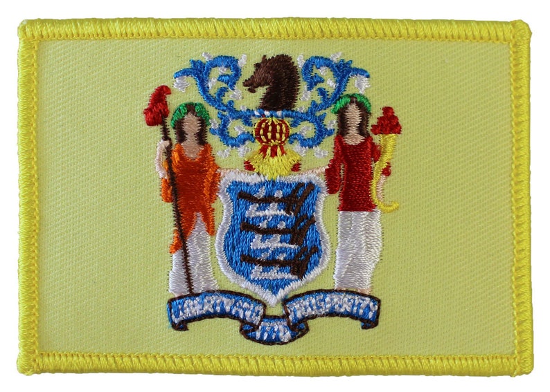 May include: A yellow embroidered patch featuring the state seal of New Jersey. The seal depicts a horse, two women, and a shield with three blue and white stripes. The text "LIBERTY AND PROSPERITY" is displayed on a blue ribbon.