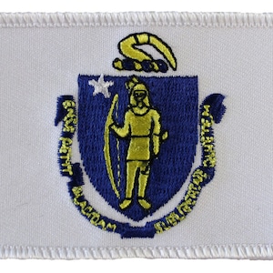 May include: White embroidered patch with the state seal of Massachusetts. The seal features a blue shield with a gold figure holding a bow and arrow, surrounded by the words "Ense petit placidam sub libertate quietem".