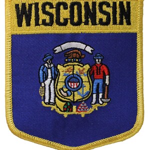 May include: Embroidered patch featuring the word "WISCONSIN" in black on a yellow background. The patch has a blue shield design with the state seal, including figures and a banner. The border is yellow.