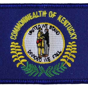 May include: Embroidered patch featuring the state seal of Kentucky. The seal depicts two figures shaking hands, surrounded by a wreath of yellow and green leaves. The text "Commonwealth of Kentucky" and "United We Stand, Divided We Fall" are inscribed around the seal.