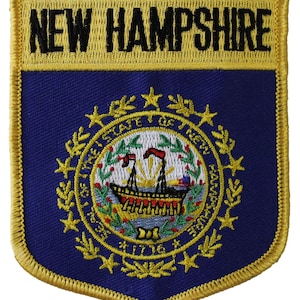 May include: Embroidered patch featuring the state seal of New Hampshire. The seal depicts a ship sailing on a body of water with a rising sun behind it. The seal is surrounded by a wreath of green leaves and stars. The words "State of New Hampshire" are written around the seal. The patch is edged in gold thread and has the words "New Hampshire" written across the top in black thread.