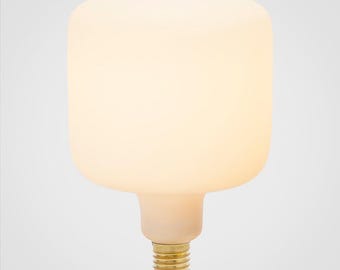 May include: A large, frosted glass light bulb with a rectangular shape. The bulb emits a warm, soft glow. The base is a standard size with a brass finish. The overall design is modern and minimalist.