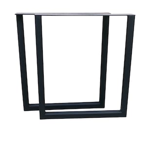 May include: Two black metal table legs with a rectangular frame. The legs are made of sturdy metal and have a simple, modern design.