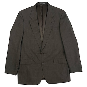 May include: A dark gray blazer with a single button closure and two flap pockets. The blazer has a subtle plaid pattern and is made of a woven fabric.