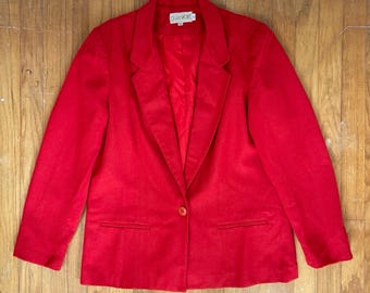 May include: A red blazer with a single button closure and a label that reads "Claudette".